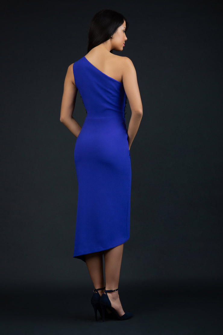 Model wearing the Diva Winslow dress in asymmetric design, one shoulder in spectrum indigo colour back image