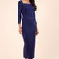 brunette model wearing diva catwalk maxi plain three quarter sleeve dress with pleating on shoulders and square neckline in navy blue front