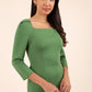 brunette model wearing diva catwalk maxi plain three quarter sleeve dress with pleating on shoulders and square neckline in vineyard green front