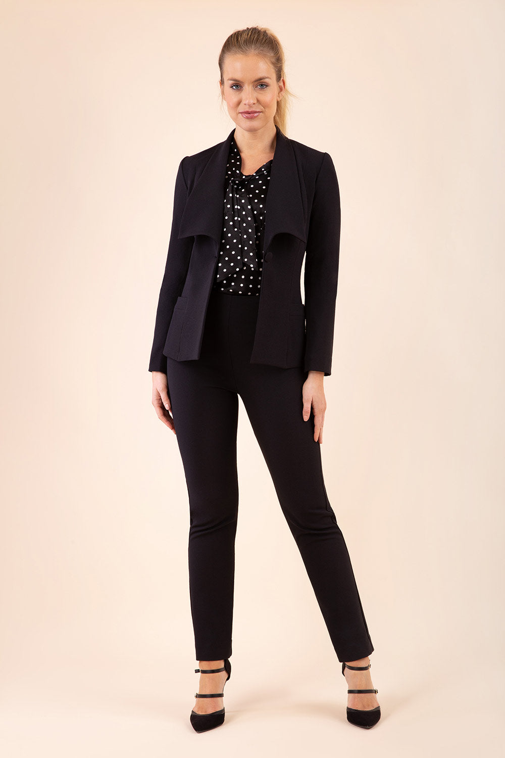 Blonde model wearing Diva Catwalk Fulica Long Sleeve One Button Oversized Collar Jacket in Black front