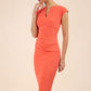 brunette model wearing diva catwalk lydia sleeveless pencil flattering fitted plain dress with split neckline and pleating across the body sea coral front