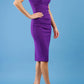 brunette model wearing diva catwalk lydia sleeveless pencil flattering fitted plain dress with split neckline and pleating across the body passion purple side