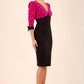 blonde model wearing diva catwalk bristow vintage three quarter sleeve pencil floral dress with low v neckline and puffed shoulders in pink polka dot top and black front