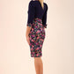 blonde model wearing diva catwalk bristow vintage three quarter sleeve pencil floral dress with low v neckline and puffed shoulders in navy top back