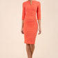 brunette model wearing diva catwalk best selling lydia pencil sleeved dress with slit at the neckline and pleating across the tummy in colour sea coral front