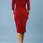 model wearing Diva Catwalk pencil three quarter sleeve dress with a split neckline and pleating across the tummy in merlot red back