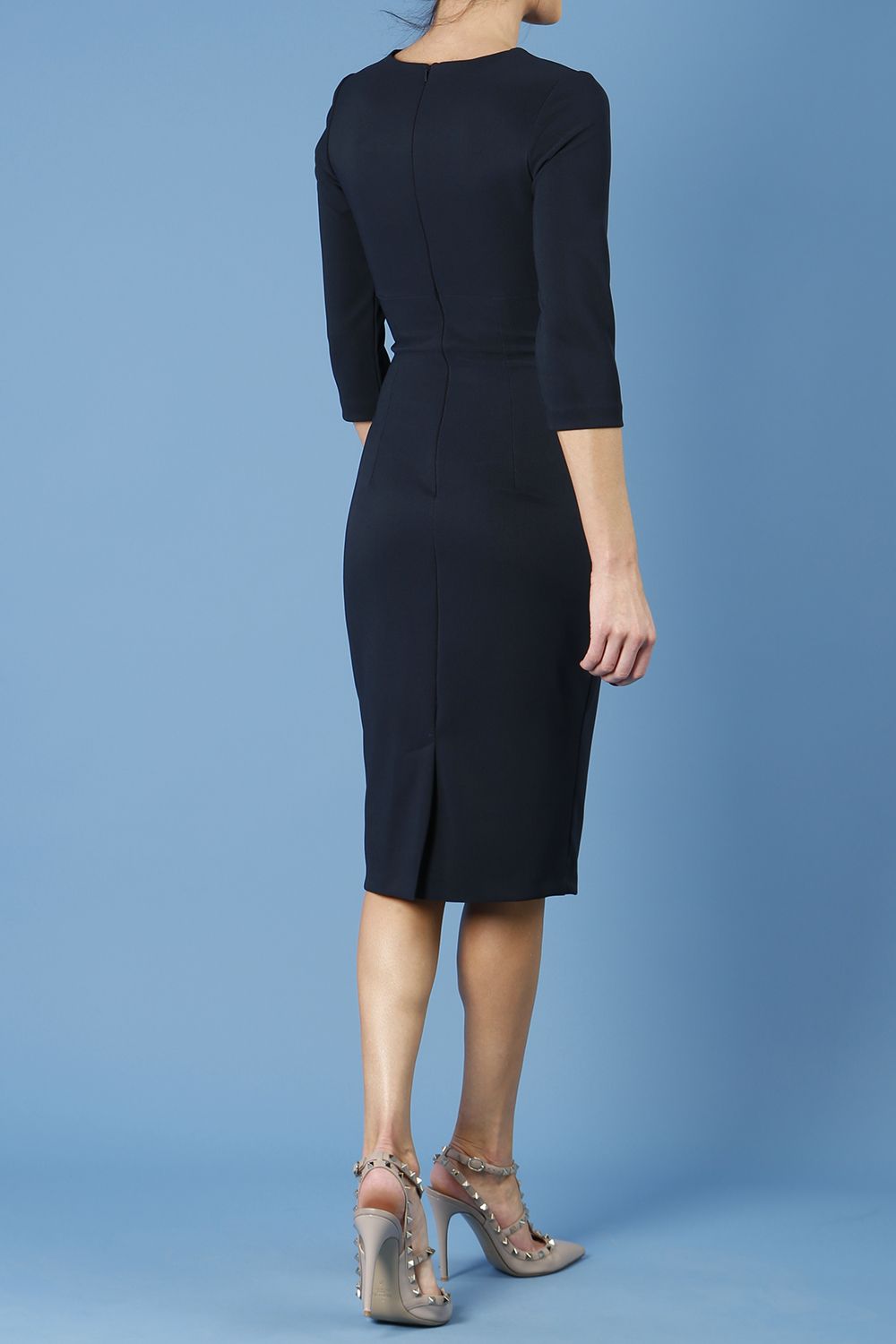 model wearing Diva Catwalk pencil three quarter sleeve dress with a split neckline and pleating across the tummy in midnight blue back