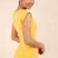 brunette model wearing Diva catwalk Suzy pencil sleeveless dress with v-neckline and wide wasteland in radiant yellow back