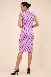Brunette model wearing Diva Catwalk Perry Polka Dot Pencil Sleeveless Dress with tie detail on a side and rounded neckline in pink back