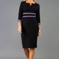 brunette model wearing Diva catwalk Paeonia dress square neckline with a vent in black with Dusky Lilac and black stripes around the waist and three quarter sleeve with Dusky Lilac contrast finish front