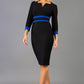 brunette model wearing Diva catwalk Paeonia dress square neckline with a vent in black with Monaco Blue and black stripes around the waist and three quarter sleeve with monaco blue contrast finish front