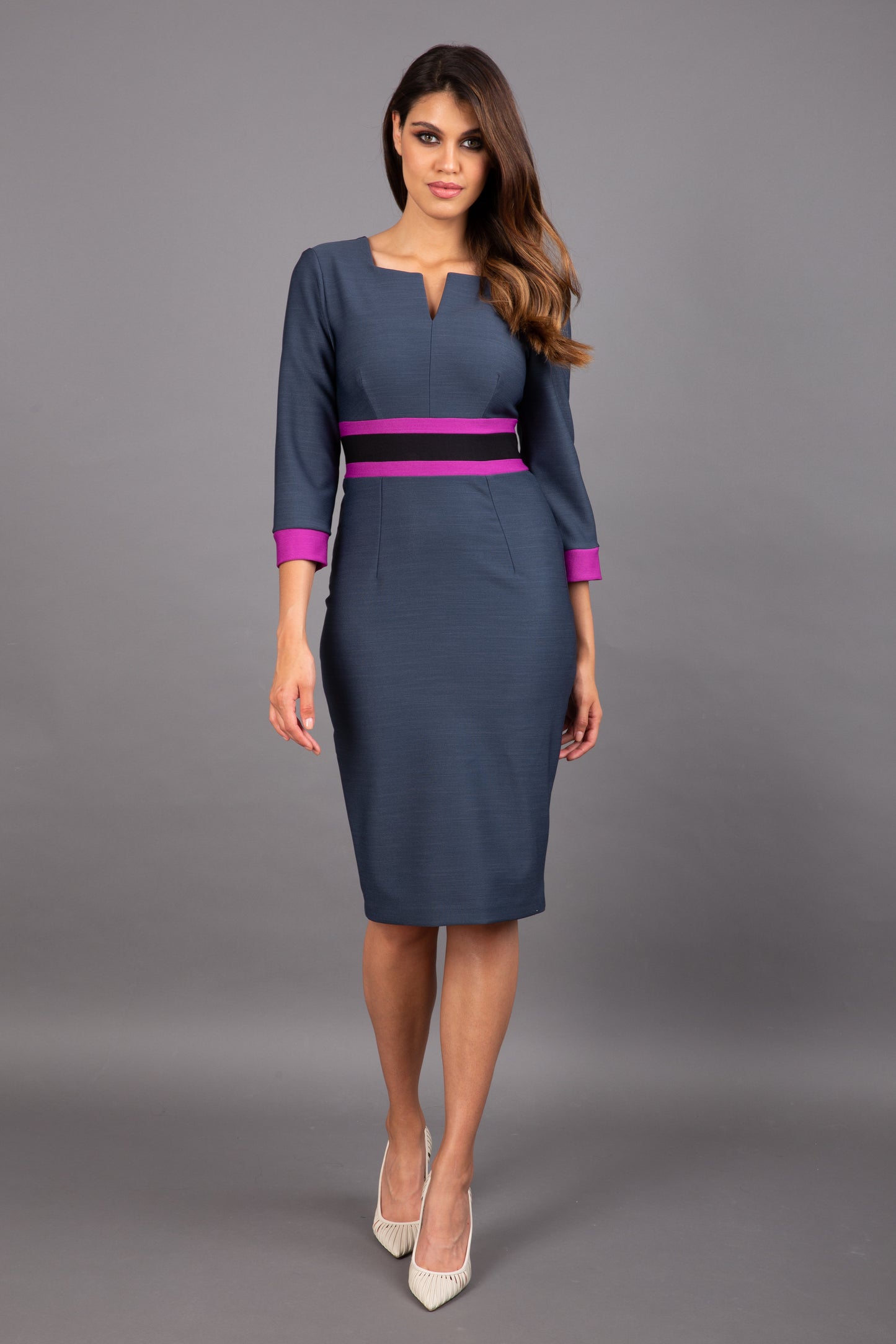 brunette model wearing Diva catwalk Paeonia dress square neckline with a vent in slate grey with dawn purple and black stripes around the waist and three quarter sleeve with dawn purple contrast finish front