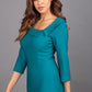 Model wearing Diva catwalk Opulus pencil dress in pacific green with three quarter sleeve figure fitted front image