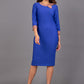 Model wearing Diva catwalk Branwen pencil figure fitted dress in monaco blue with  three quarter sleeve and acorn brown  bow detail  front image