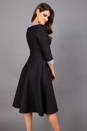 Model wearing Diva catwalk Coralia swing dress in black/ slate grey with three quarter sleeve figure fitted back image