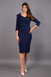 Model wearing Diva catwalk Venetia pencil figure fitted dress in navy blue with three quarter sleeve front