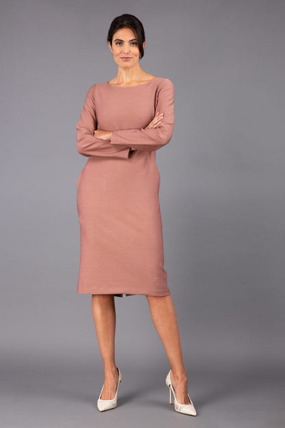 brunette model wearing diva catwalk cora white pencil dress with long sleeves and rounded neckline with pockets in colour acorn brown on side front