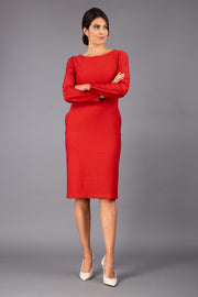 brunette model wearing diva catwalk cora white pencil dress with long sleeves and rounded neckline with pockets in colour garnet red on side front
