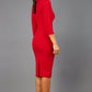 brunette model wearing diva catwalk elodie pencil fitted dress with rounded neckline and button detail and three quarter sleeve with pleating across the body from side triangle detail in scarlet red back