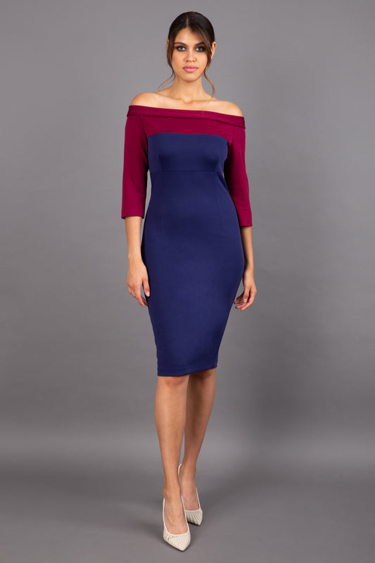 brunette model wearing diva catwalk leon pencil contrast dress with boat off shoulder fold over neckline and three quarter sleeve and empire waistline in navy blue and blissful burgundy front
