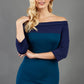 blonde model wearing diva catwalk leon pencil contrast dress with boat off shoulder fold over neckline and three quarter sleeve and empire waistline in teal and navy blue front