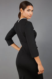 brunette model wearing diva catwalk masie little black dress with elizabethan collar and two-tone contrast neckline with 3 4 sleeves and is a pencil style dress back