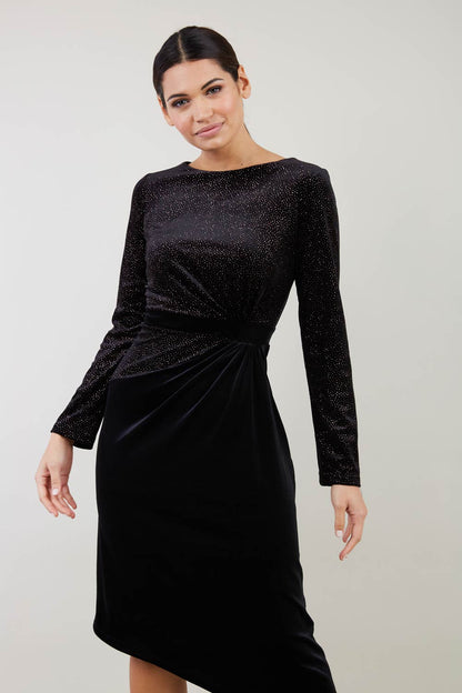 Brunette Model wearing assymetric glitter and black velvet long sleeve dress front image