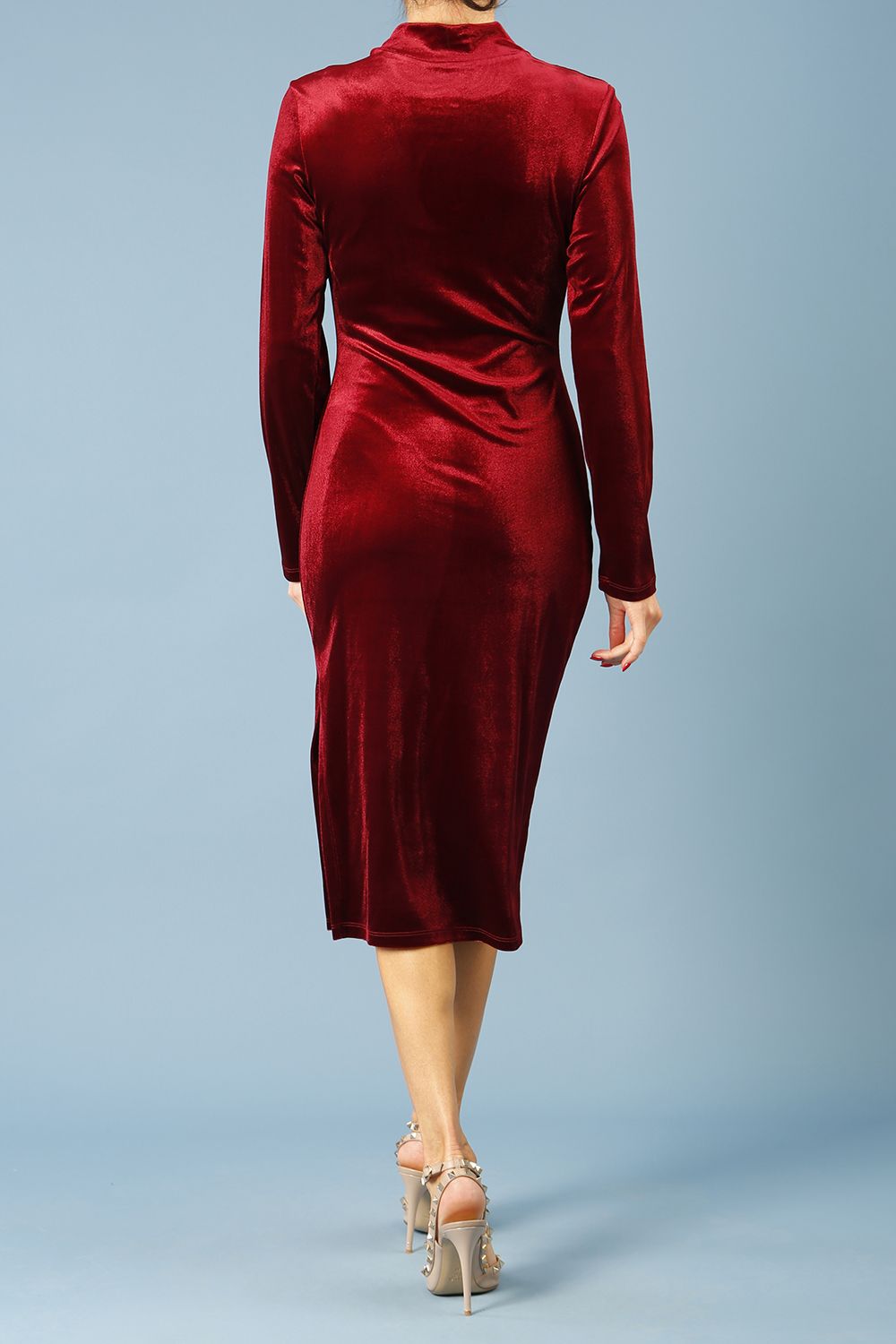 brunette model wearing diva catwalk clipper pencil skirt dress velvet sleeved style with a keyhole detail and high neck and split on a side of the skirt in colour burgundy back