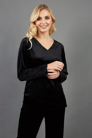 blonde model wearing diva catwalk dahlia asymmetric velvet top with sleeves in black front