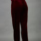 model wearing diva catwalk pelham stretch velvet straight leg trousers in velvet with ribbon in burgundy colour back