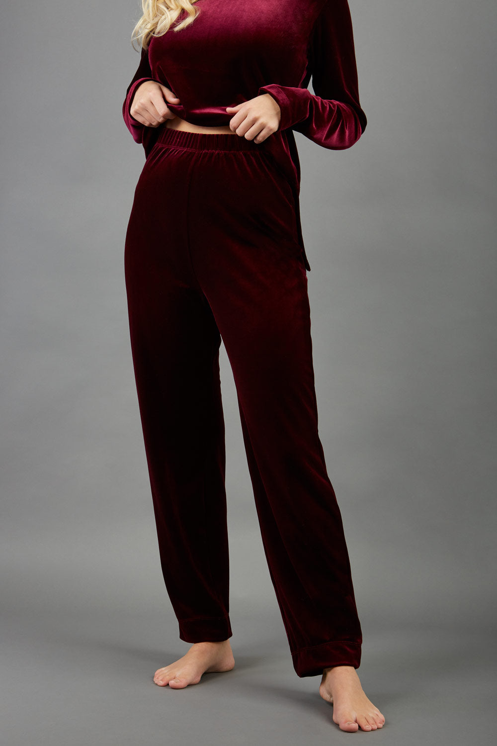 model wearing diva catwalk pelham stretch velvet straight leg trousers in velvet with ribbon in burgundy colour front