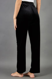 model wearing diva catwalk pelham stretch velvet straight leg trousers in velvet with ribbon in black colour back