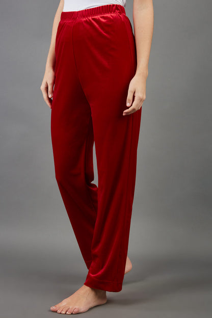 model wearing diva catwalk pelham stretch velvet straight leg trousers in velvet with ribbon in red colour front