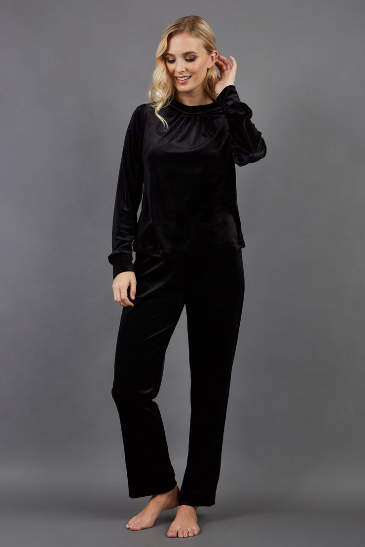 blonde model is wearing diva catwalk allium velvet sleeved high neck top in colour black front paired with diva black velvet trousers