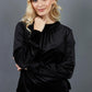 blonde model is wearing diva catwalk allium velvet sleeved high neck top in colour black front