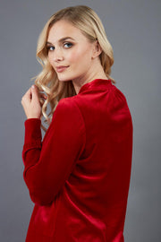 blonde model is wearing diva catwalk allium velvet sleeved high neck top in colour red back