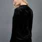 blonde model is wearing diva catwalk allium velvet sleeved high neck top in colour black back