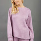 blonde model wearing diva catwalk muscari asymmetric sleeved top with rounded neck in pink front