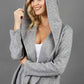 blonde model wearing diva catwalk cashmere hooded jacket with long sleeves and front waterfall closure in grey colour  front