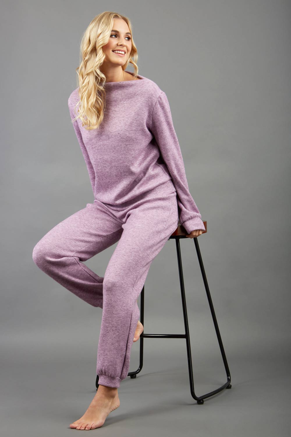 blonde model wearing diva catwalk hudson top with long sleeves and boat neckline in very soft cosy cashmere fabric in pink colour front with aria joggers matching the top front
