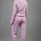 blonde model wearing diva catwalk hudson top with long sleeves and boat neckline in very soft cosy cashmere fabric in pink colour front with aria joggers matching the top back
