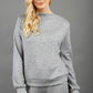 blonde model wearing diva catwalk hudson top with long sleeves and boat neckline in very soft cosy cashmere fabric in grey colour front with aria joggers matching the top front