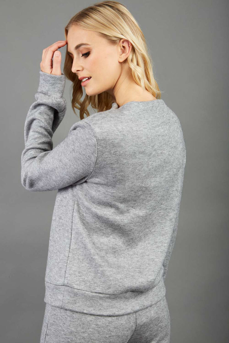 blonde model wearing diva catwalk hudson top with long sleeves and boat neckline in very soft cosy cashmere fabric in pink colour front with aria joggers matching the top back