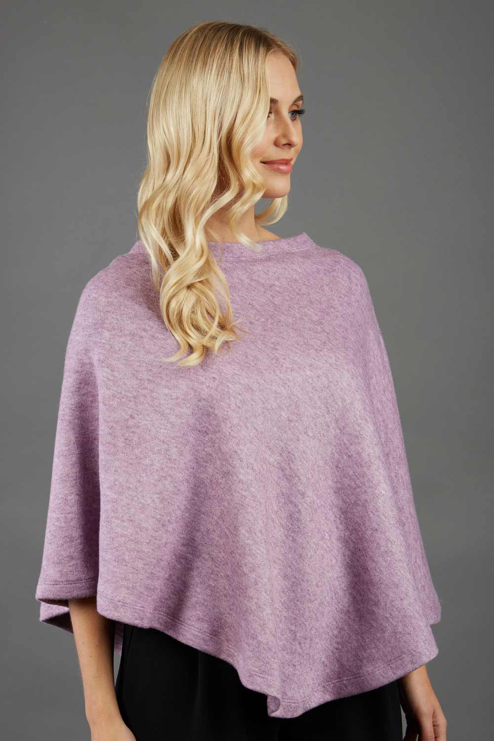 blonde model wearing diva catwalk rosalia poncho made in very cosy soft cashmere fabric in pale pink front