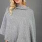 blonde model wearing diva catwalk rosalia poncho made in very cosy soft cashmere fabric in flint grey front