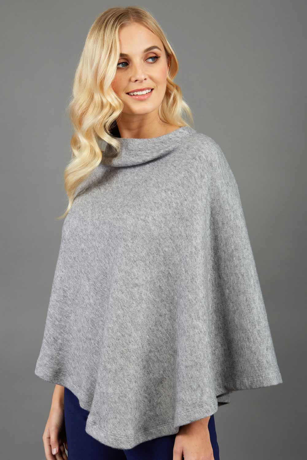 blonde model wearing diva catwalk rosalia poncho made in very cosy soft cashmere fabric in flint grey front
