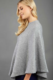 blonde model wearing diva catwalk rosalia poncho made in very cosy soft cashmere fabric in flint grey side