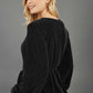 Blonde hair model is wearing a jersey sparkle v neck wrap blouse with bishop sleeve detail and bow on a side front back