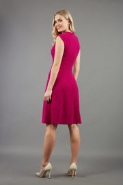 blonde model is wearing diva catwalk sleeveless swing skirt dress with asymmetric neckline in pink back