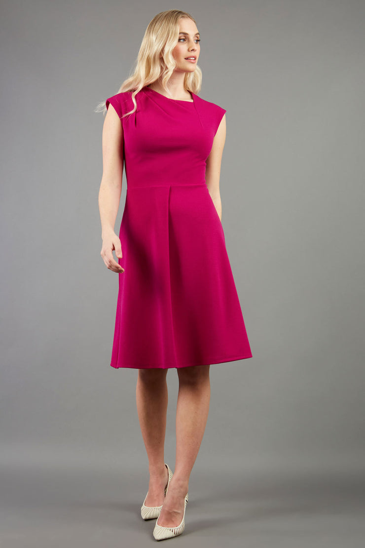 blonde model is wearing diva catwalk sleeveless swing skirt dress with asymmetric neckline in pink front
